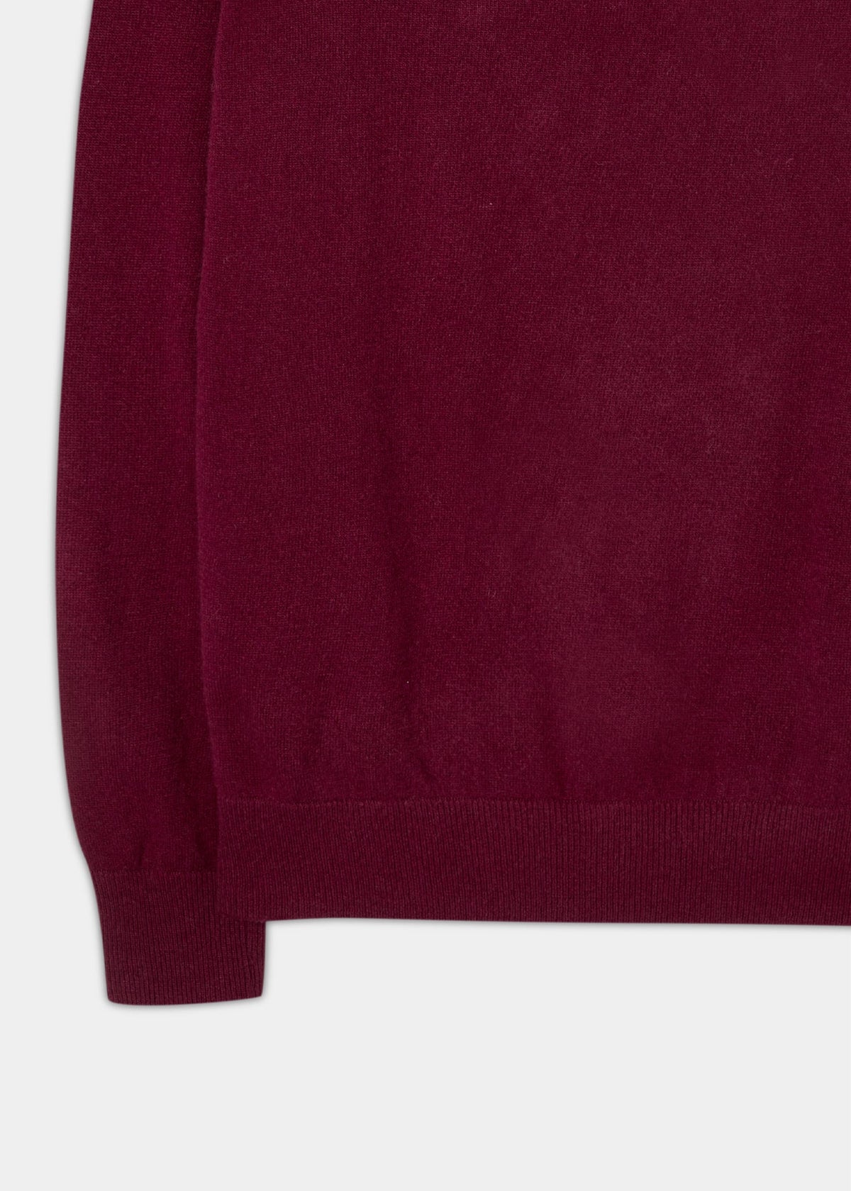 Close-up of the Cairns Geelong Wool Quarter Zip Jumper in Claret, focusing on its ribbed hem and cuff.