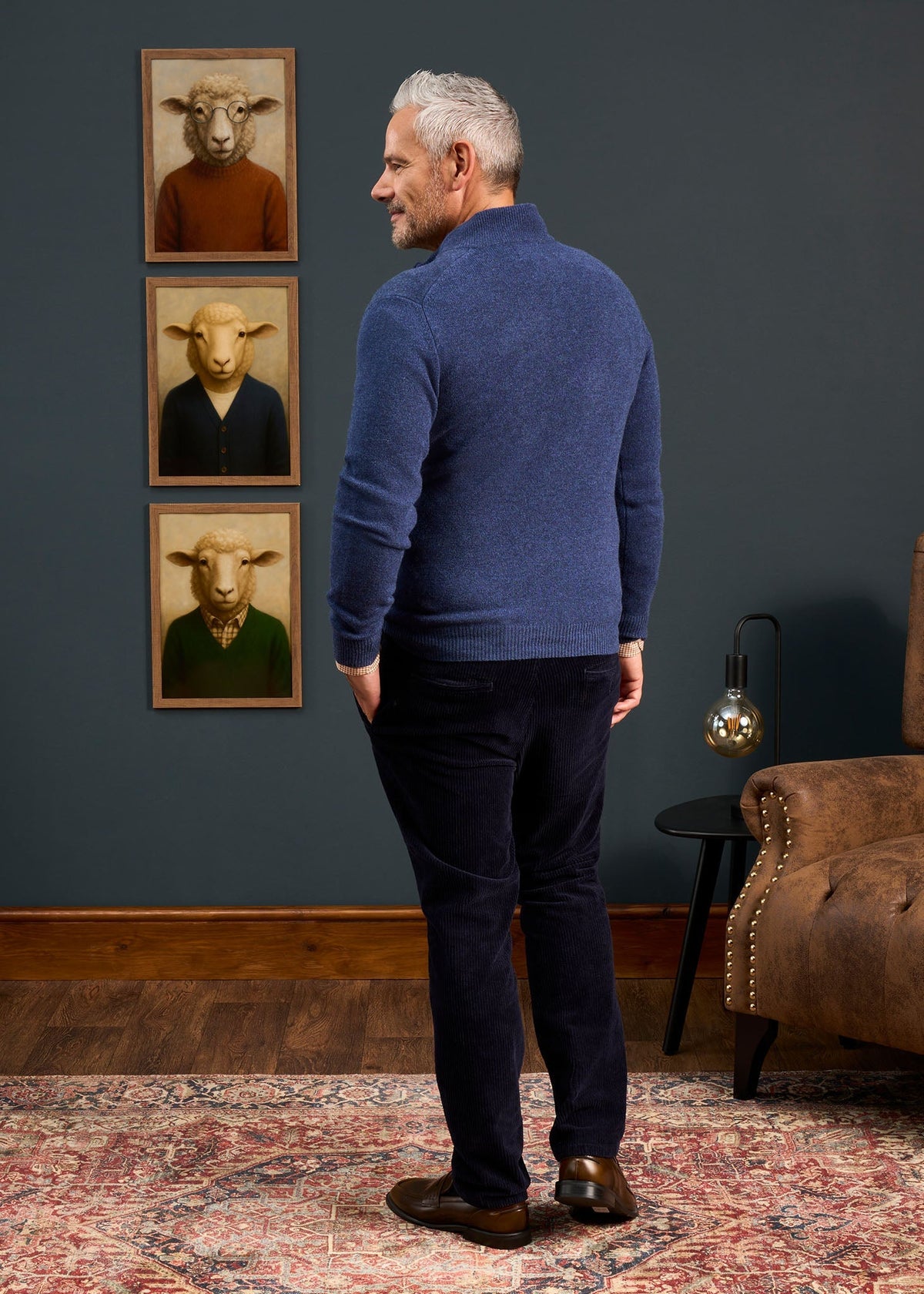 Man in profile wearing a Sutherland Lambswool Quarter Zip Jumper In Rhapsody and dark trousers.