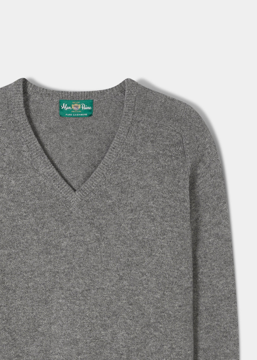 Selkirk Pure Cashmere V-Neck Jumper In Derby: grey cashmere v-neck with a branded green label at the inner neckline.