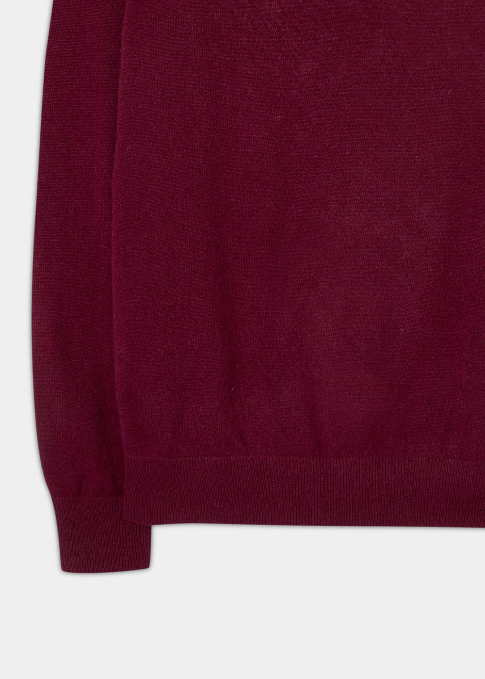 Close-up of the Cairns Geelong Wool Quarter Zip Jumper in Claret, focusing on its ribbed hem and cuff.
