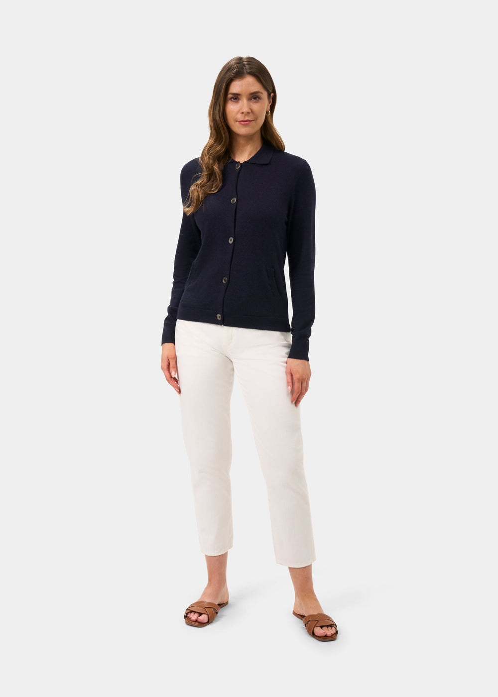 Womens cardigan in navy knit with button front and ribbed cuffs, model wearing white trousers