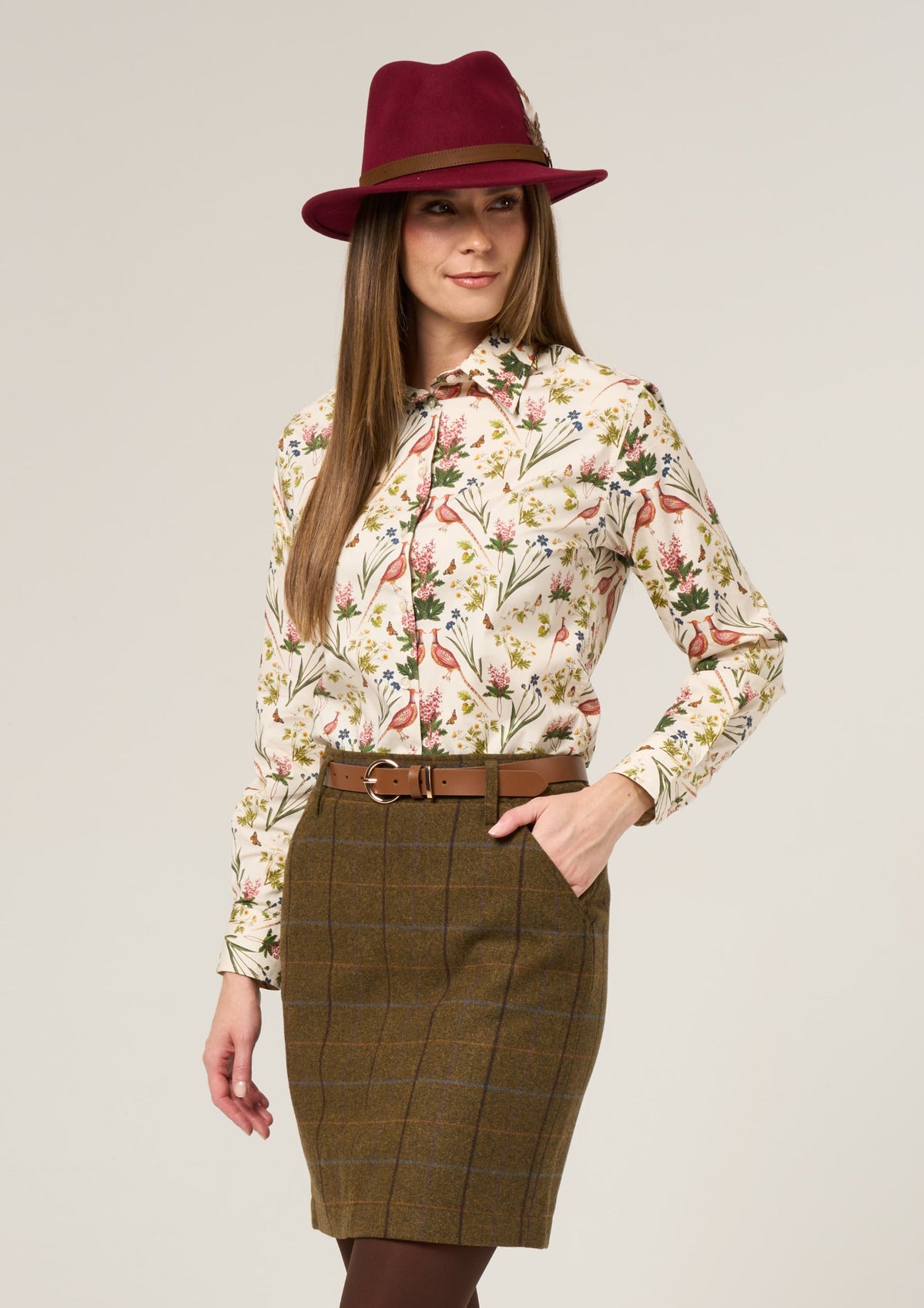 Woman wears Lawen Cotton Printed Shirt in Cream Floral Design, smiling with one hand in her pocket.