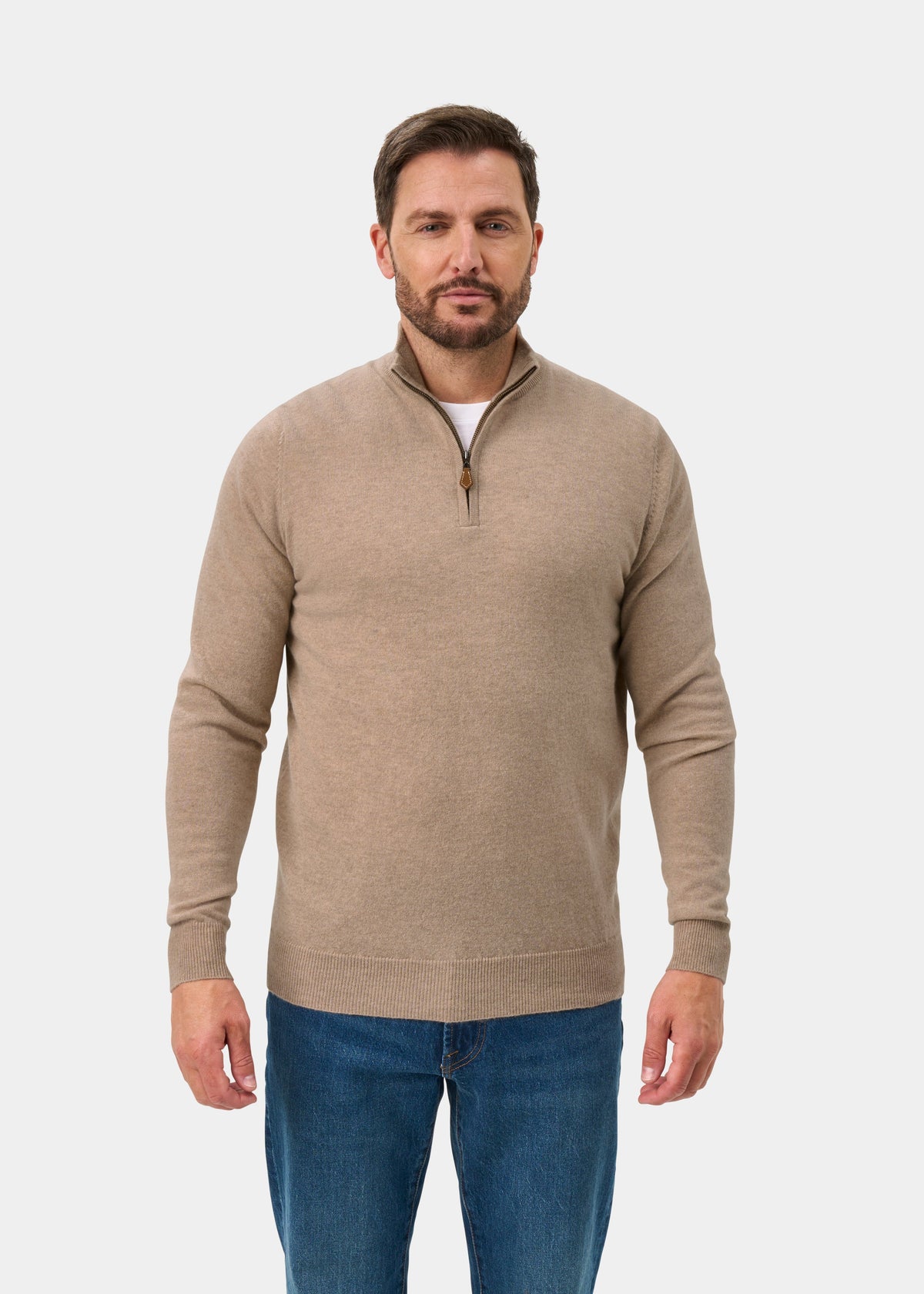 Man wears Hanbury Pure Cashmere Quarter Zip Jumper in Linen, regular fit, with blue jeans against a white background.