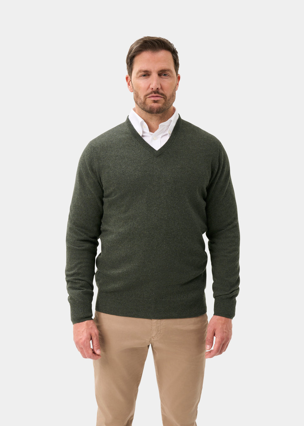 Man in Haddington Pure Cashmere V-Neck Jumper in rosemary, white shirt, and khaki pants on white background.