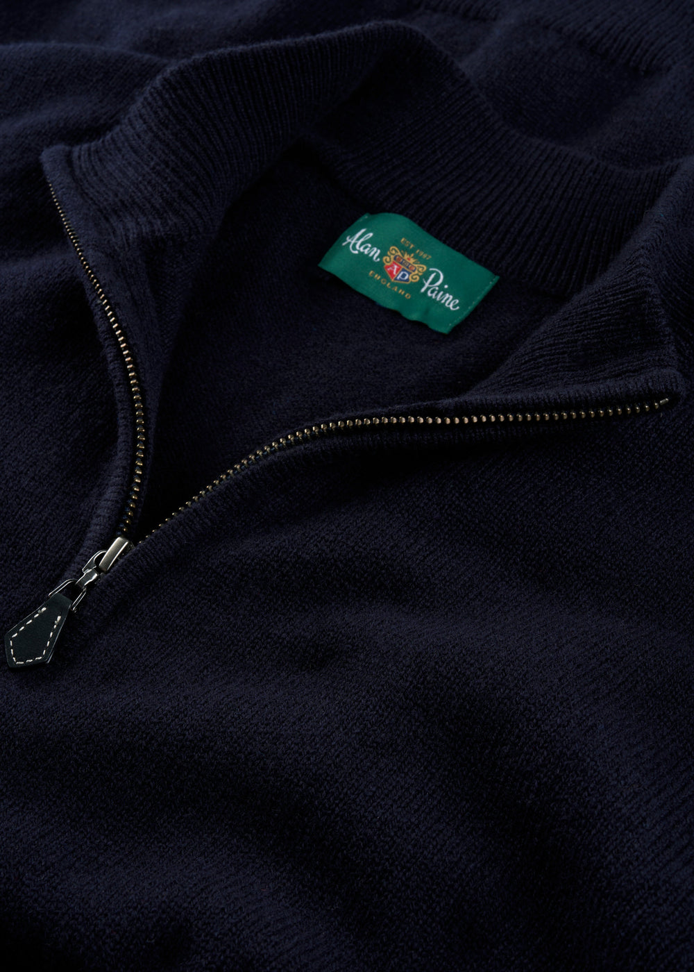 Sutherland Lambswool Quarter Zip Jumper In Navy with a ribbed collar and metal zipper.