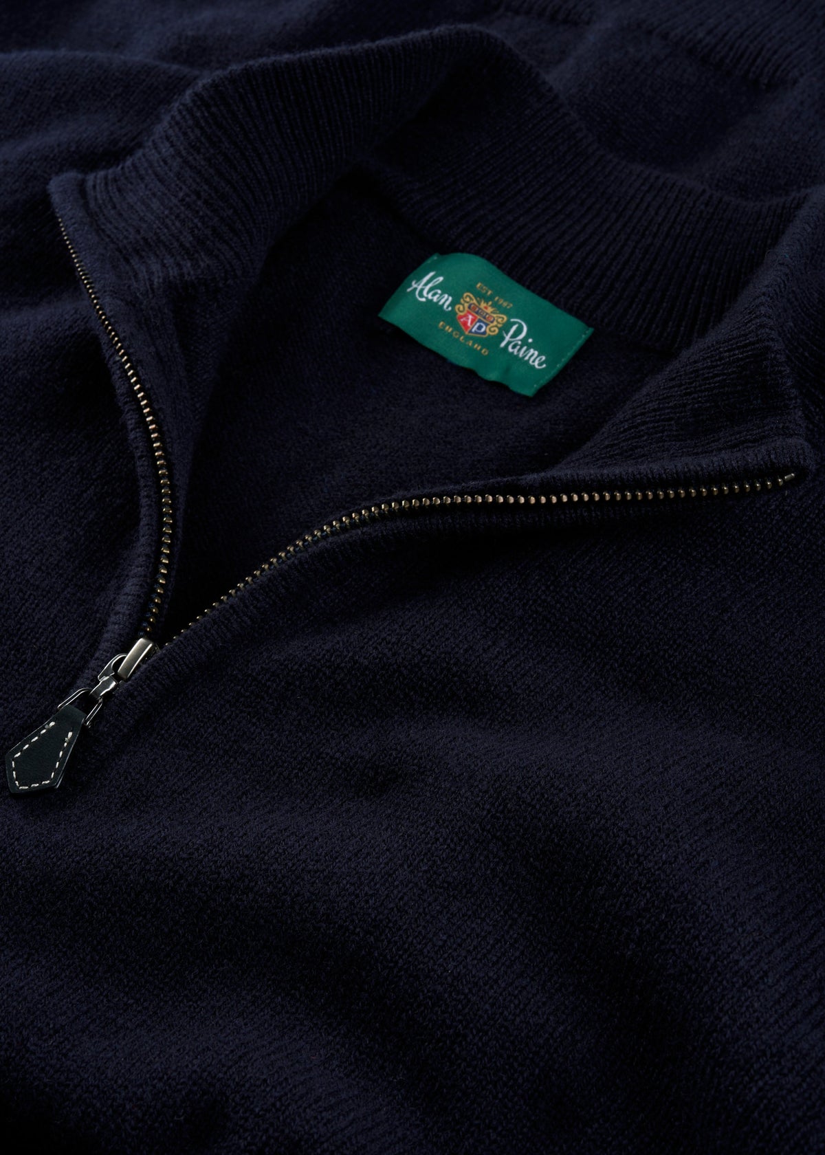 Sutherland Lambswool Quarter Zip Jumper In Navy with a ribbed collar and metal zipper.