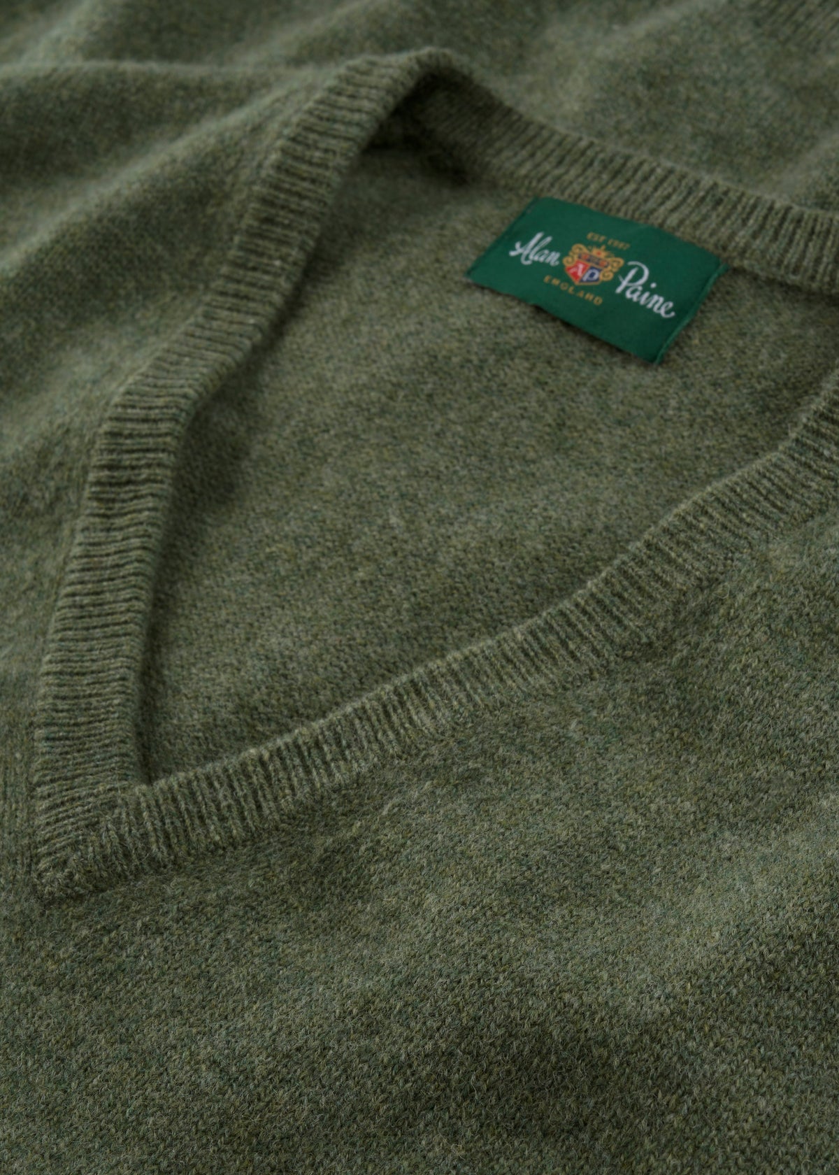 Norfolk Lambswool V-Neck Slipover In Landscape olive green V-neck sweater with a ribbed neckline and saddle shoulder.