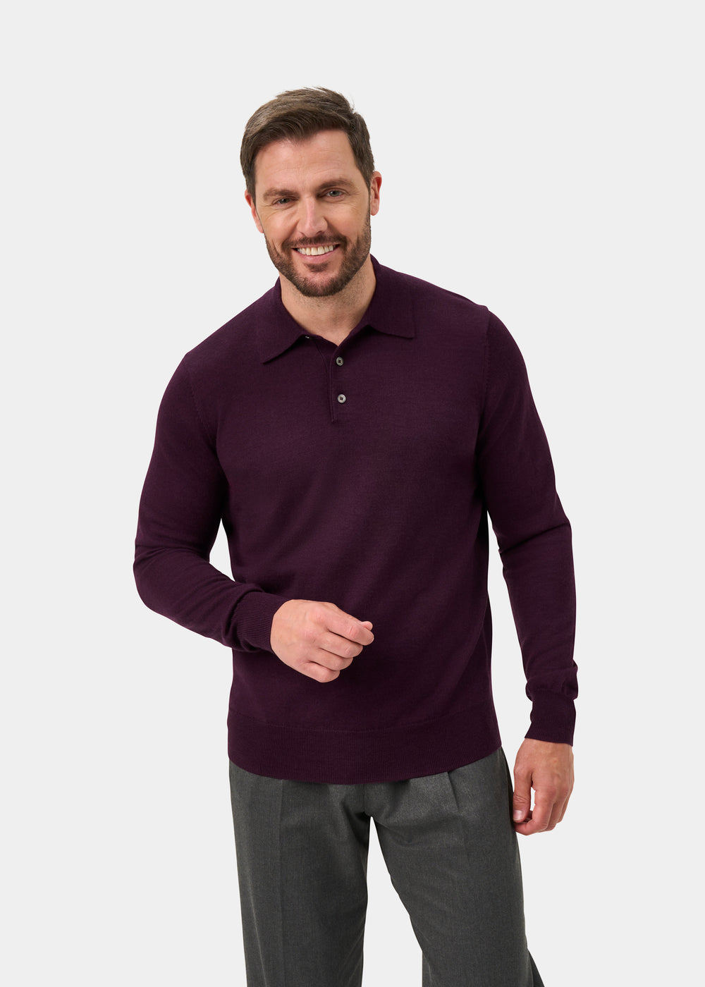 Smiling man wears the Hindhead Men’s Merino Wool Polo Shirt in Black Grape, regular fit, against a plain background.