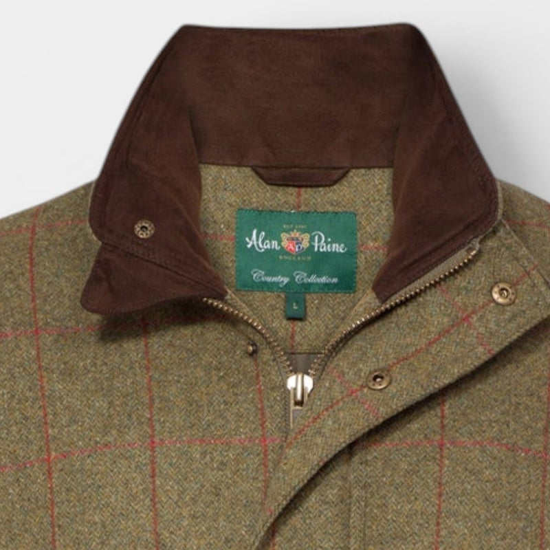 A classic tweed jacket in brown and beige with a red windowpane check pattern, featuring a dark brown corduroy collar and front flap pockets, photographed against a light gray background.