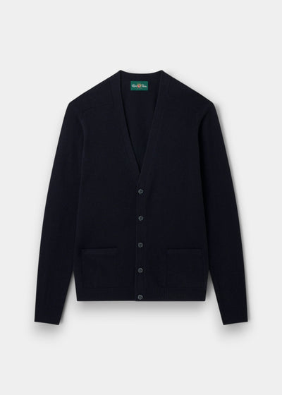Navy Cornwall lambswool V-neck cardigan, classic fit, with long sleeves, buttons, and two front pockets on white.