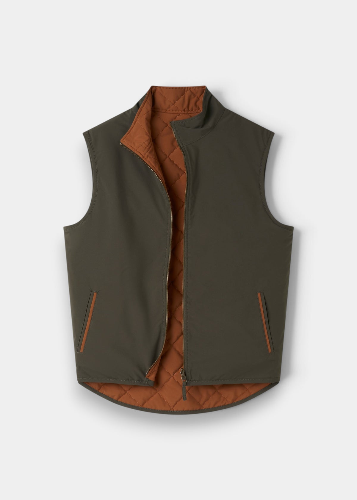Swifthall Reversible City Gilet In Olive and Cider: an olive green quilted, water-resistant vest with a rust lining.