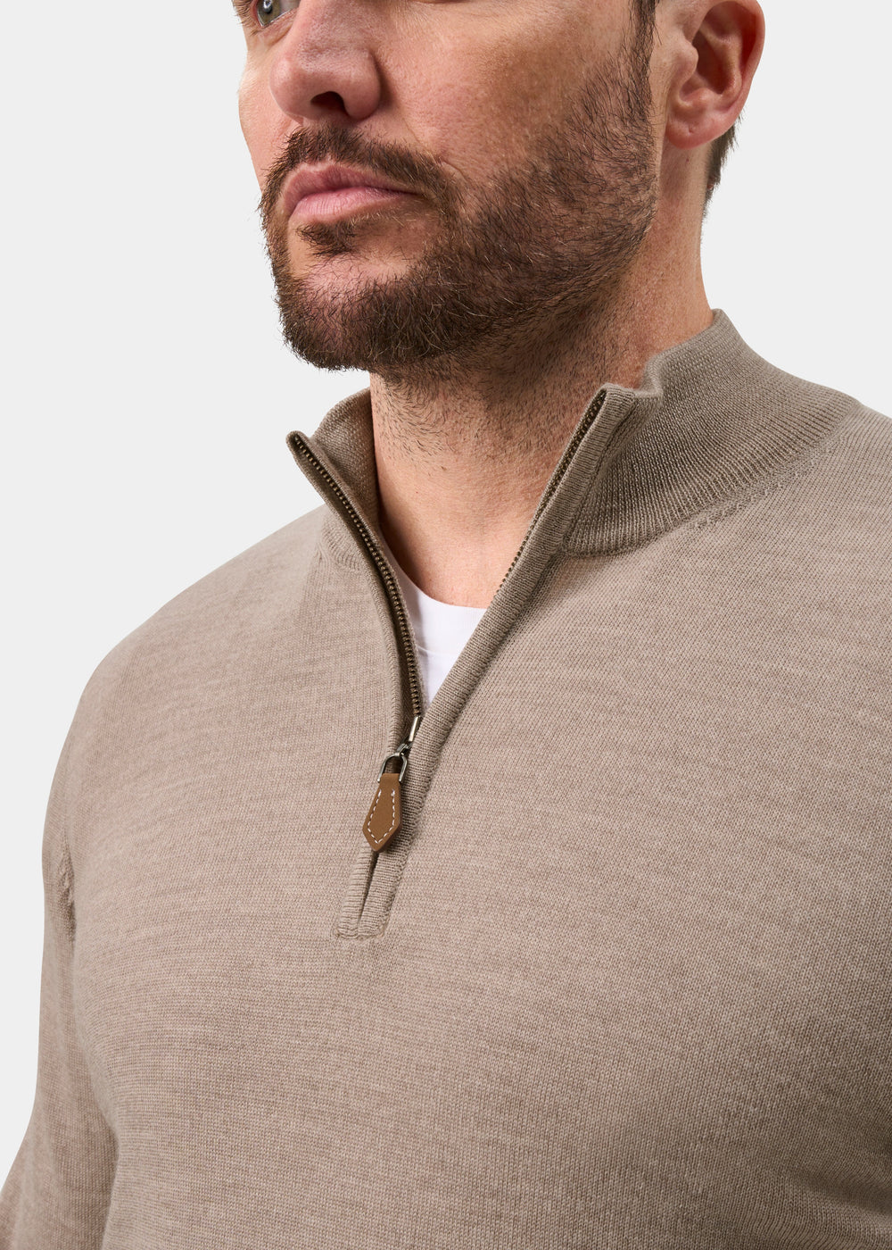 Man in Barton Merino Wool Quarter Zip Jumper in Cobble, regular fit, over white shirt, plain background.