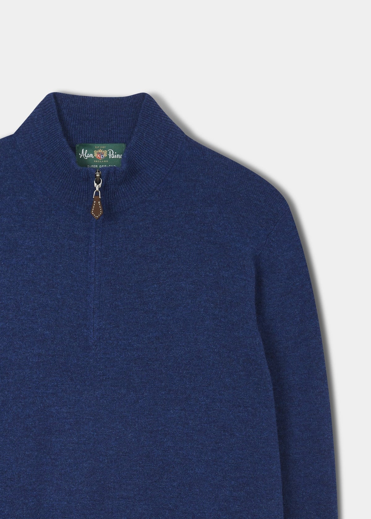 Cairns Geelong Wool Quarter Zip Jumper in indigo, brown zipper pull, green collar label, on white background.
