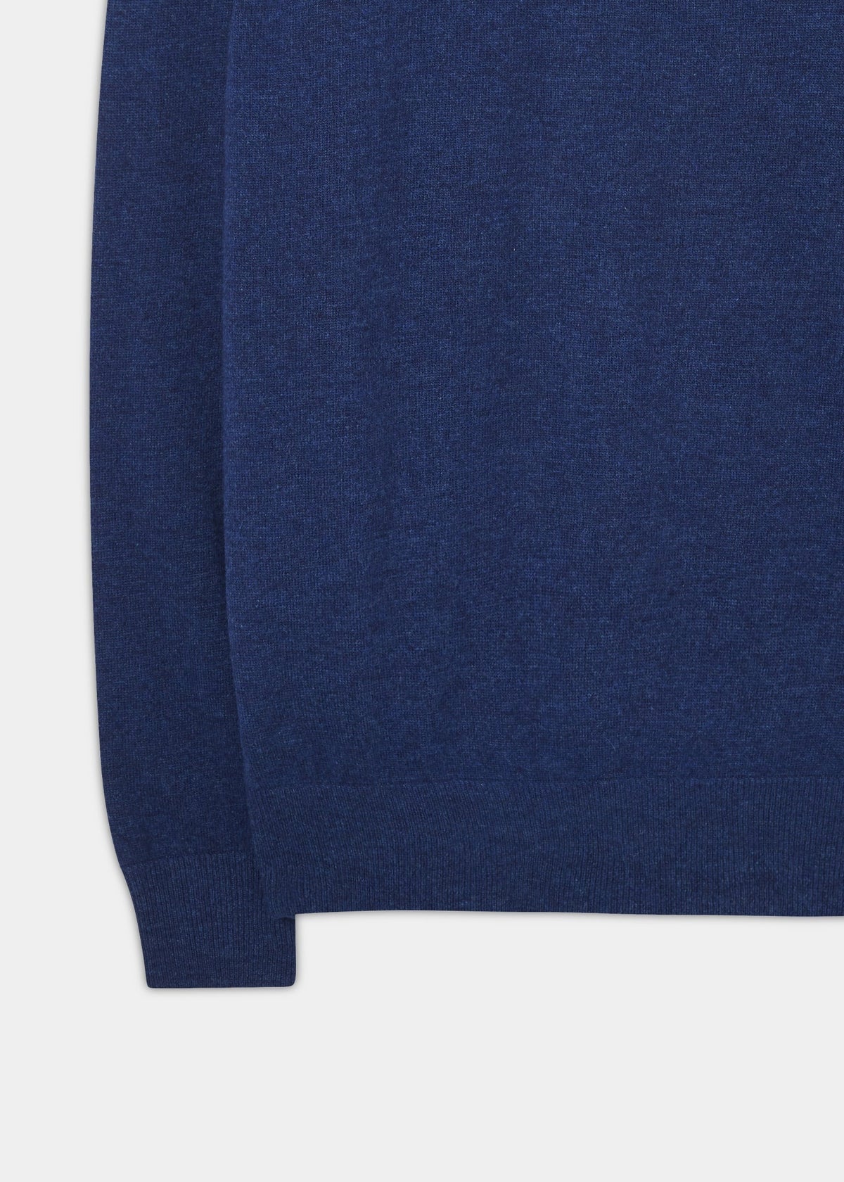 Close-up of the Cairns Geelong Wool Quarter Zip Jumper in Indigo, showing hem and sleeve against a white background.