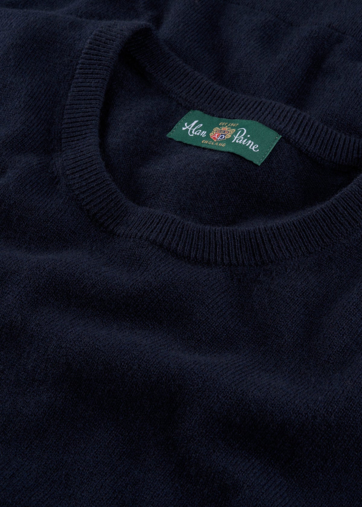 Ivy Wool & Cashmere Crew Neck Jumper in dark navy, features a green Alan Paine label on the collar, laid flat.