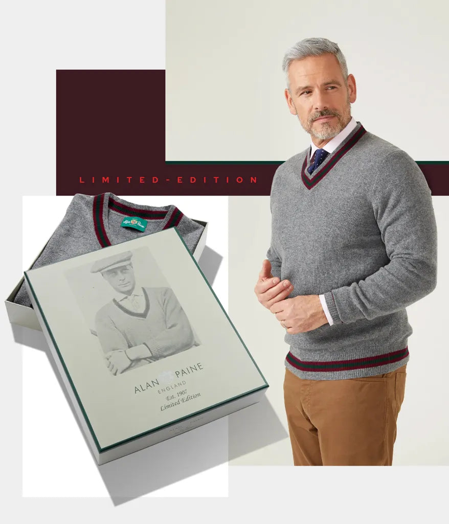 Man in gray stands by a boxed Limited Edition Commemorative Lambswool Sweater in Grey Mix, Alan Paine label visible.
